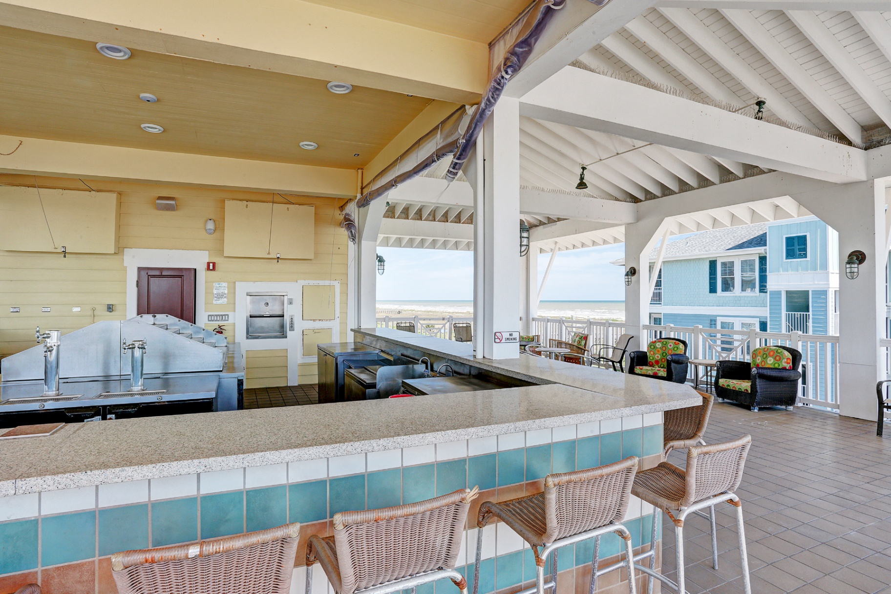 Open-air beach club bar with gulf view